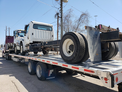 semi trucks on step deck trailer